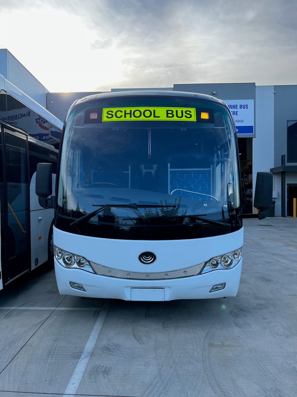 Photo of the front of a Yutong D9 bus with Safebus SB001B window mount school bus lights and Victorian school bus lights large signage installed