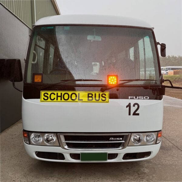 Photo of the front of a 2018 4th generation BE6 Mitsubishi Rosa bus with Safebus SB001B window mount Victorian school bus lights and signage installed