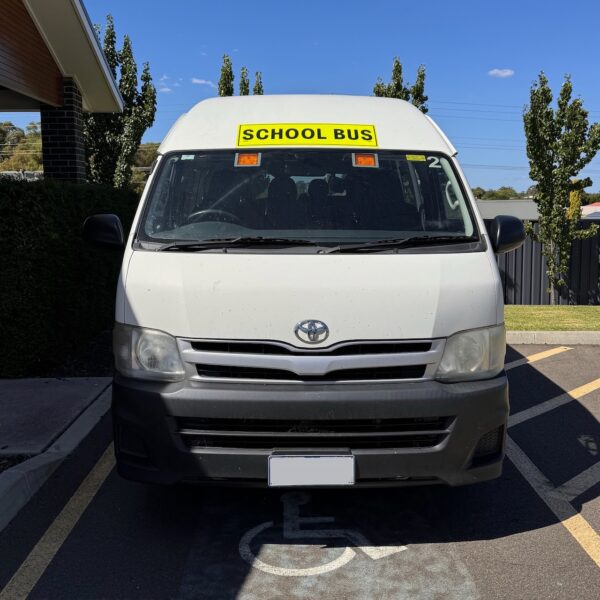 Photo of the front of a 2013 5th generation Toyota HiAce Commuter bus with Safebus interior mount Victorian school bus lights and signage installed