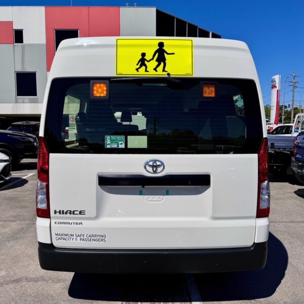 Photo of the rear of a 2023 6th generation Toyota HiAce Commuter bus with Safebus interior mount Victorian school bus lights and signage installed