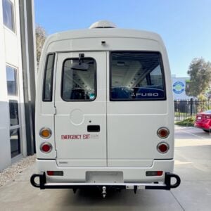 Photo of the rear of a Mitsubishi Rosa with a towbar with platform and black loop protectors