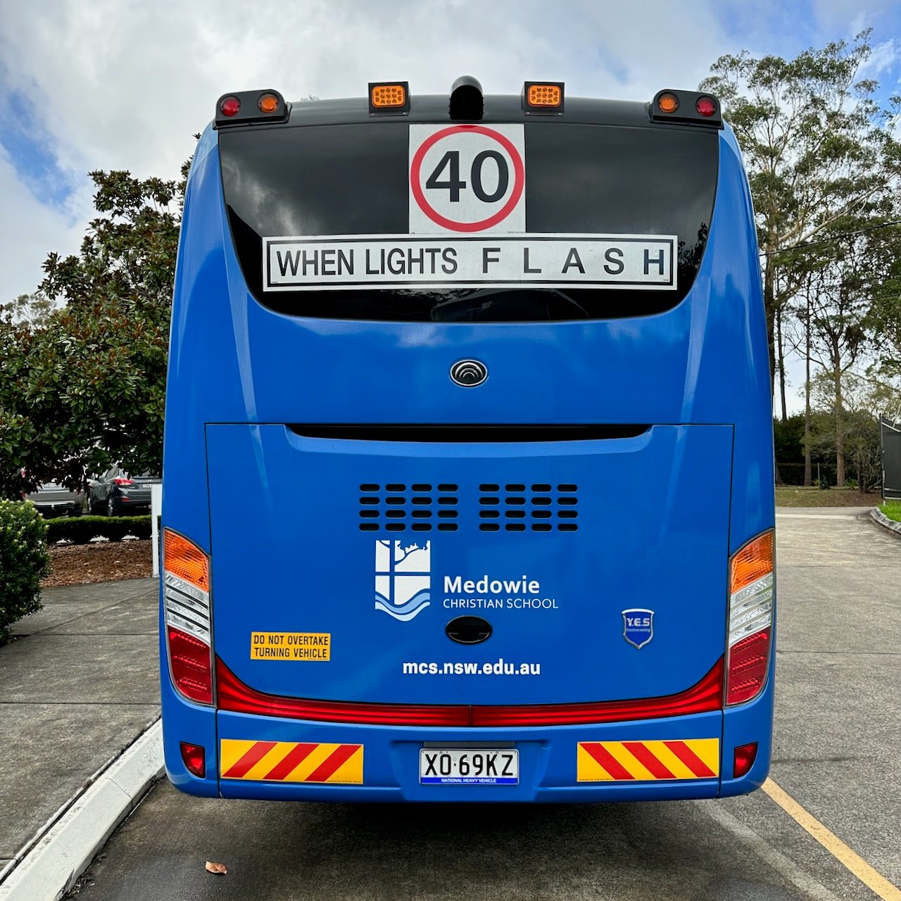 Photo of the rear of a Yutong D9 bus with Safebus SB001A surface mount school bus lights and NSW TS150 signage installed
