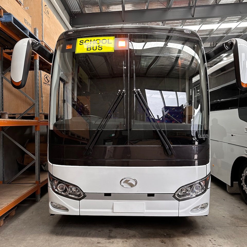 Photo of the front of a 57 seater King Long bus with Safebus SB001B window mount school bus lights and Victorian signage installed