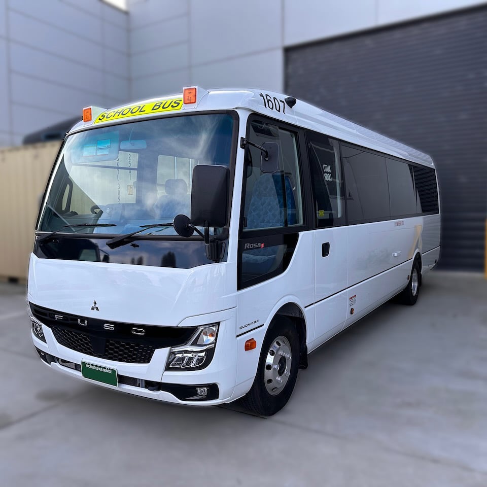 Photo of the front of a Mitsubishi Rosa bus with Victorian school bus lights and signage installed