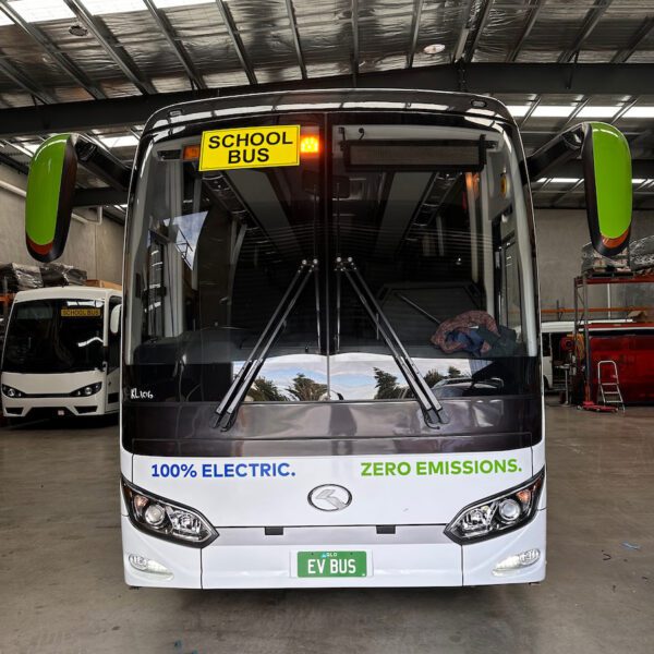 Photo of the front of a 57 seater electric EV King Long bus with Safebus SB001B window mount school bus lights and Victorian signage installed