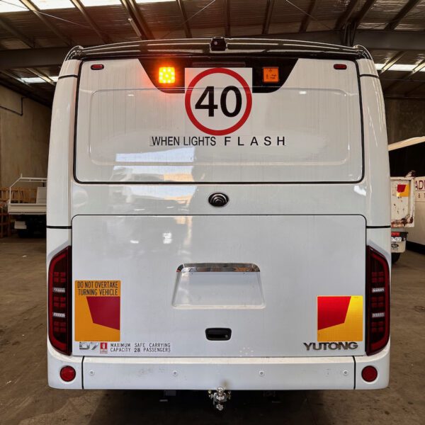 Photo of the rear of a Yutong D7 bus with Safebus SB001A surface mount school bus lights and NSW TS150 signage installed