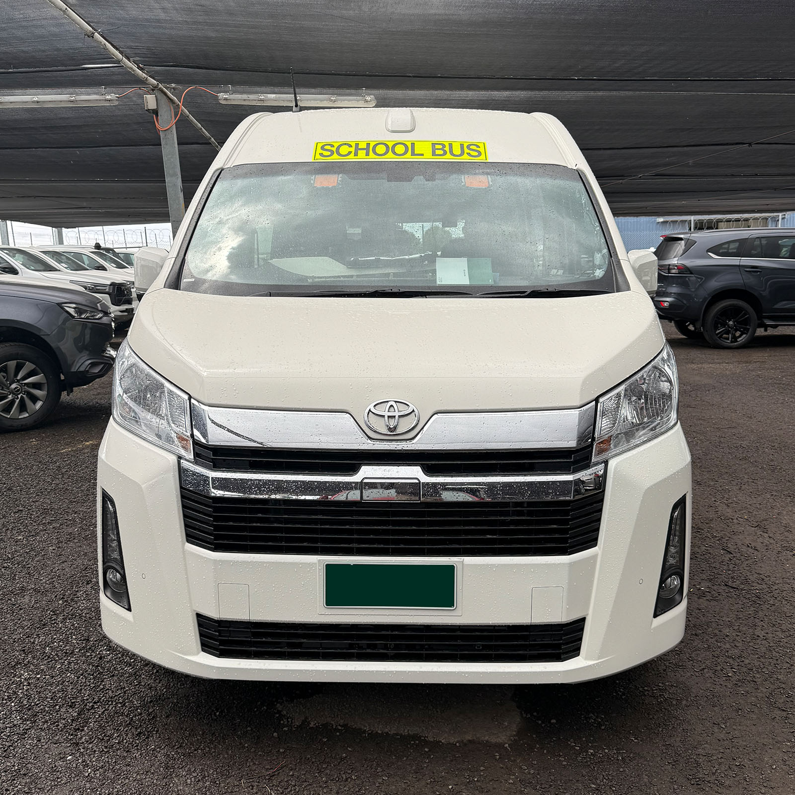 Photo of the front of a 2025 6th generation Toyota HiAce Commuter bus with Safebus interior mount Victorian school bus lights and signage installed & BF100 flasher unit