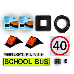 Image of the contents of the NSW TS150 school bus light kit, including school bus signage, When Lights Flash sign, front amber school bus lights in a black mount, rear school bus lights in boxes, black vinyl surround, 40km/h sign, flasher unit, switch and wiring loom