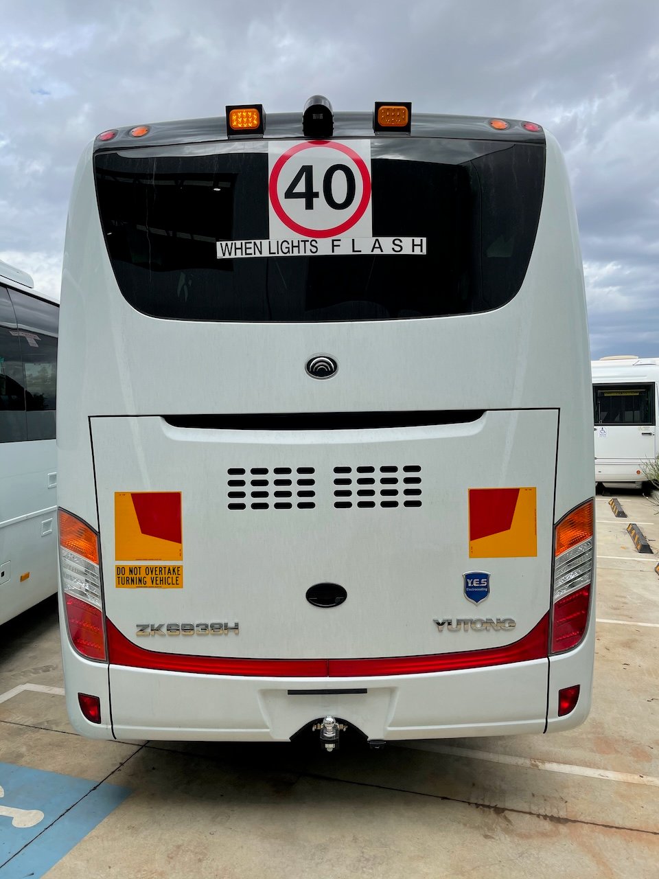 Photo of the rear of a Yutong D9 bus with Safebus SB001A surface mount school bus lights and NSW TS150 signage installed and BF100 flasher unit